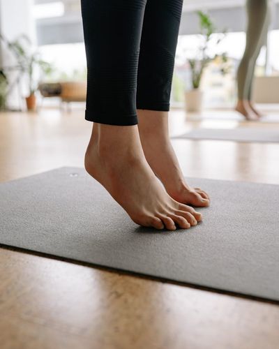 Close-up view of feet on a yoga mat during an exercise.